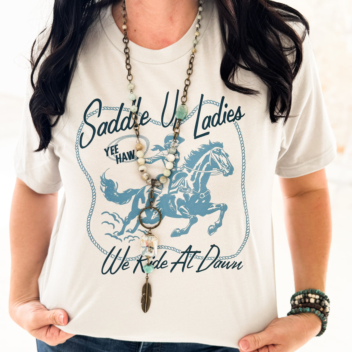 Silver We Ride At Dawn graphic T-shirt for women by Envy Stylz Wholesale, casual unisex Bella+Canvas tee with bold print.