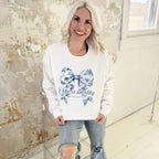 Women’s blue bow graphic sweatshirt with “She Is Worthy” text, made by Envy Stylz Wholesale, featuring a casual fit and comfortable fabric.