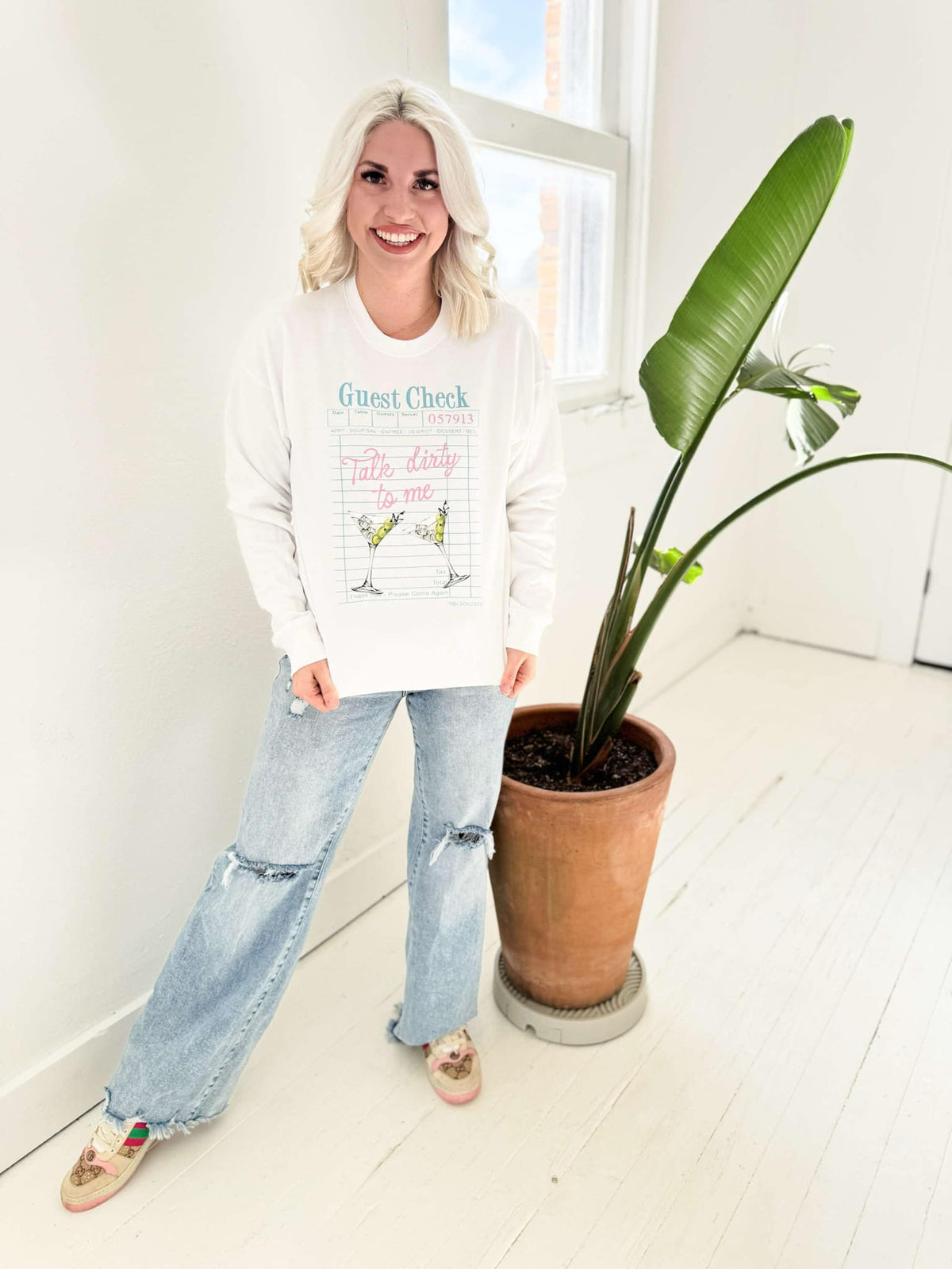 Women’s white Gildan T-shirt with "Talk Dirty To Me Martini" graphic design by Envy Stylz Wholesale.