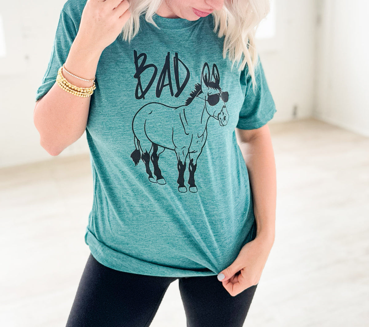 Women’s Ice Teal Bad Donkey graphic T-shirt by Envy Stylz Wholesale, casual unisex tee with bold donkey print.