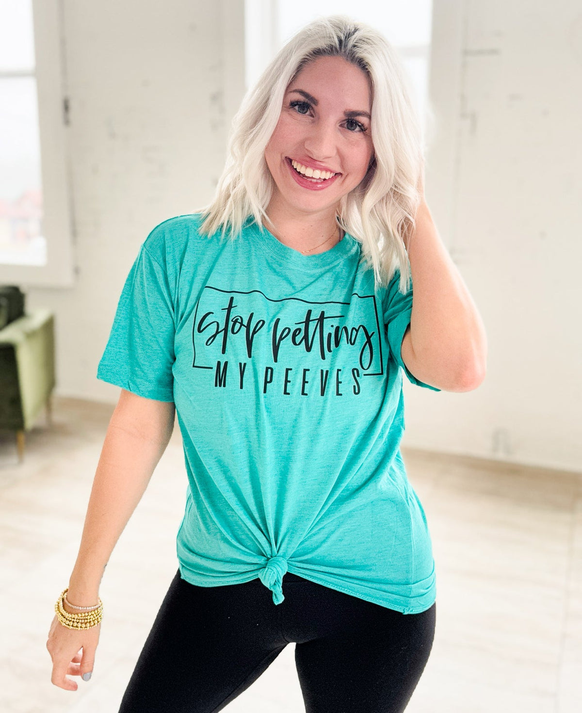 Teal women's graphic t-shirt with "Stop Petting My Peeves" slogan, casual unisex style from Envy Stylz Wholesale.