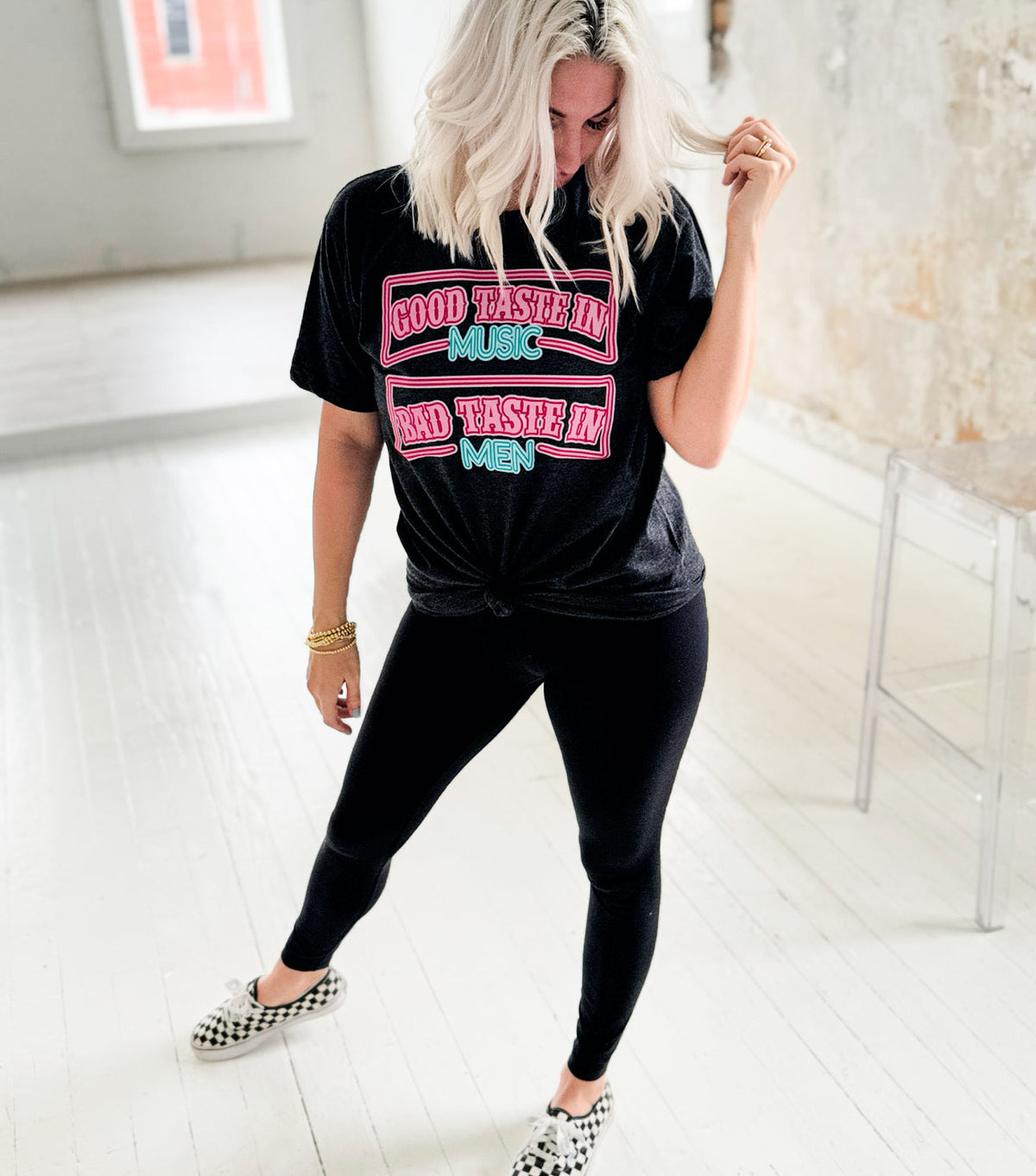 Women’s Heather Charcoal graphic t-shirt with “Good Taste In Music Bad Taste In Men” design by Envy Stylz Wholesale.