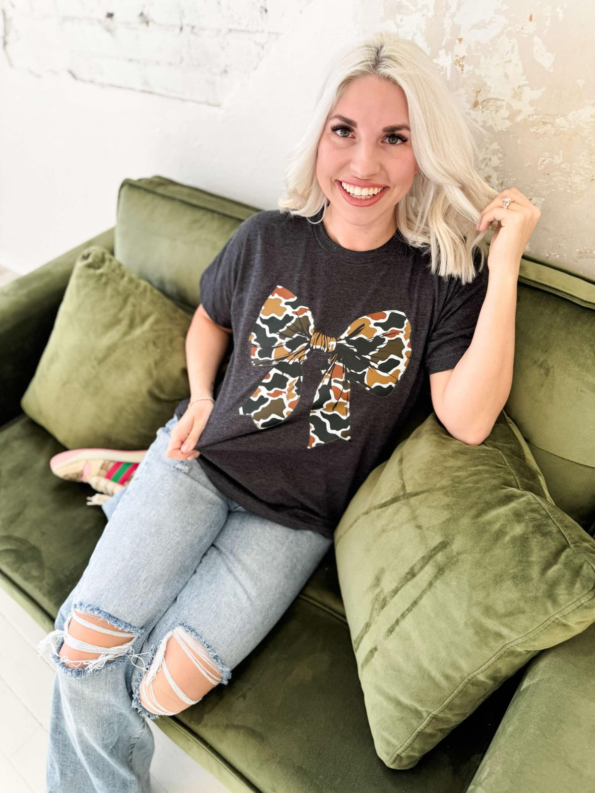 Women’s Camo Bow Graphic T-Shirt by Envy Stylz Wholesale, Heather Graphite color, casual unisex style, soft cotton fabric.
