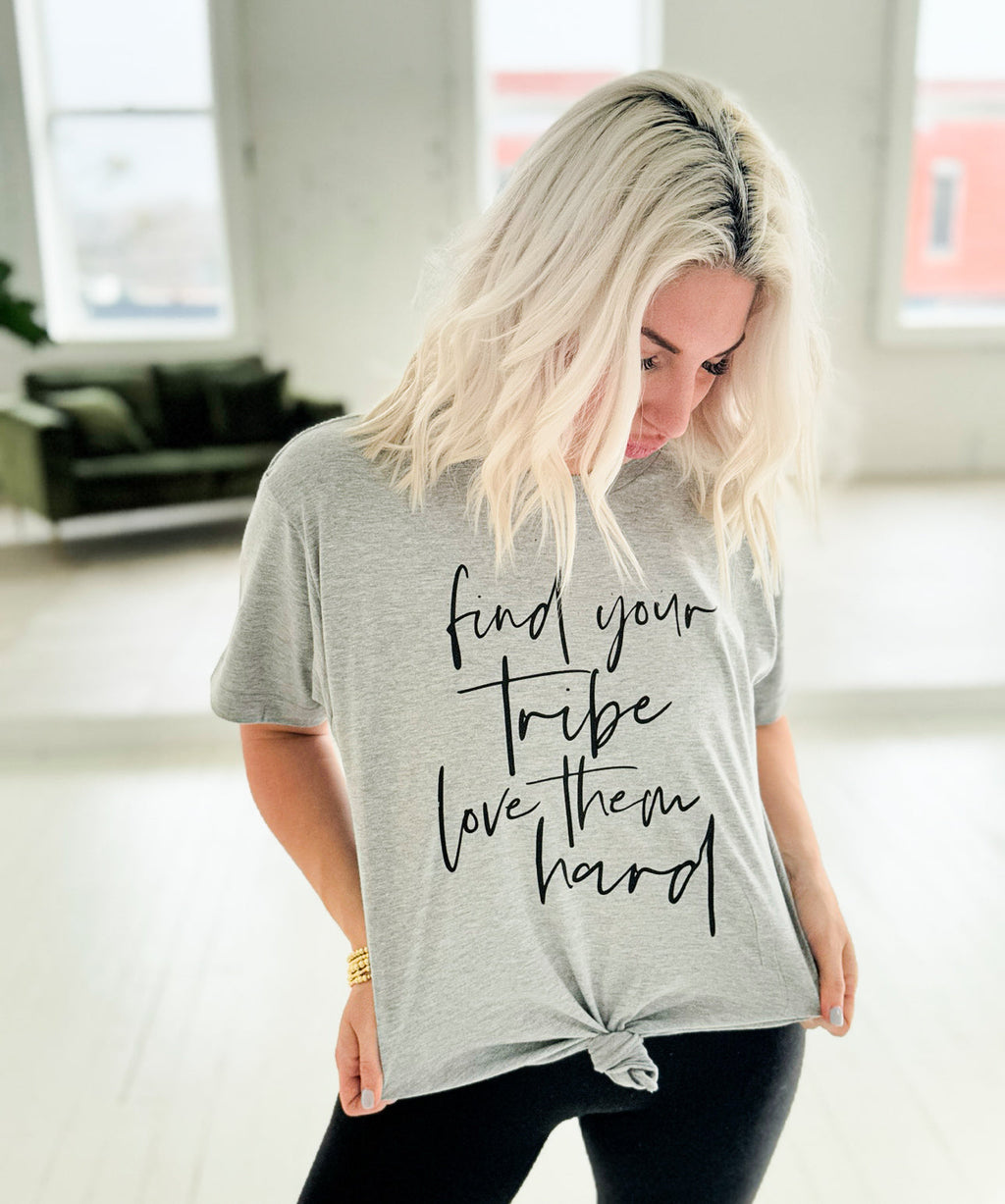 Heather grey women's graphic t-shirt by Envy Stylz Wholesale with "Find Your Tribe, Love Them Hard" design, casual unisex style.