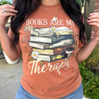 Women’s graphic T-shirt from FestiviTees featuring the phrase "Books Are My Therapy" in black print on a casual tee.