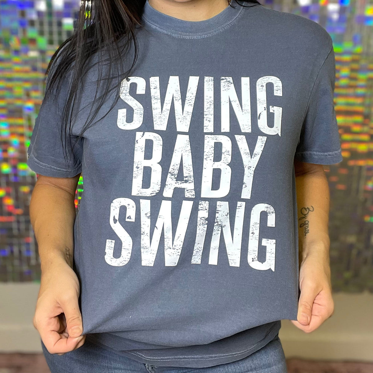 FestiviTees women's graphic t-shirt featuring a playful swing and baby swing design on denim-colored fabric.