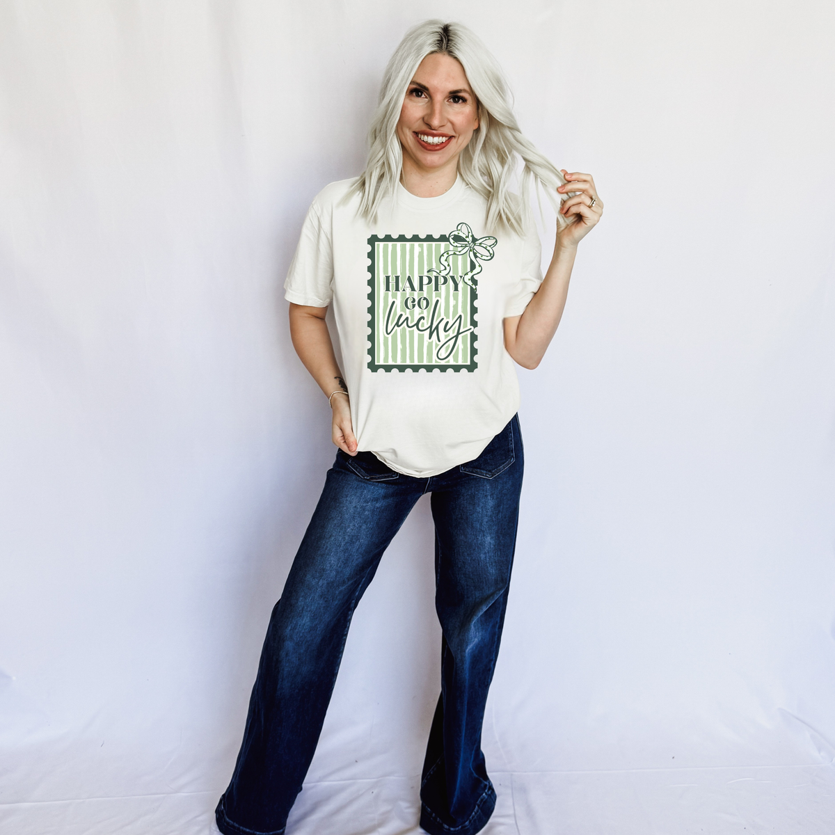 Women’s ivory Happy Go Lucky graphic T-shirt by FestiviTees, casual crew neck shirt with cheerful design.