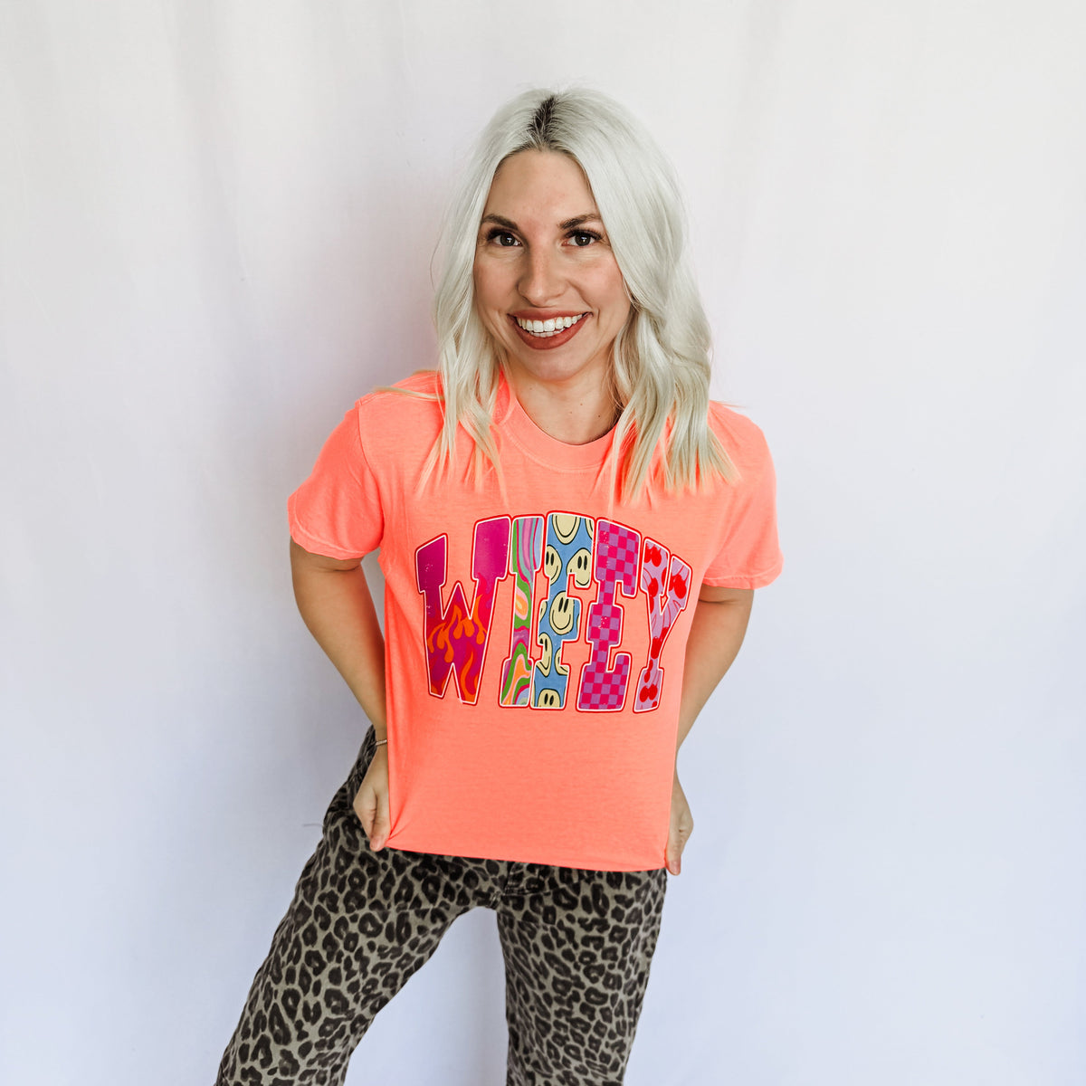 Women’s Retro Wifey Graphic Tee by FestiviTees in vibrant neon red-orange, casual short-sleeve T-shirt with retro design.