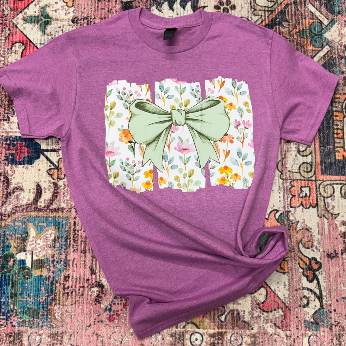 Women's Spring Bow Graphic T-Shirt by FestiviTees featuring a colorful bow design on a casual tee.