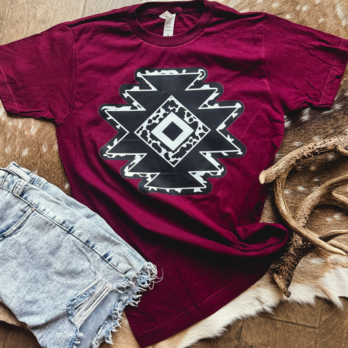 Women’s burgundy cowprint Aztec diamond graphic T-shirt by FestiviTees, featuring bold print and casual fit.