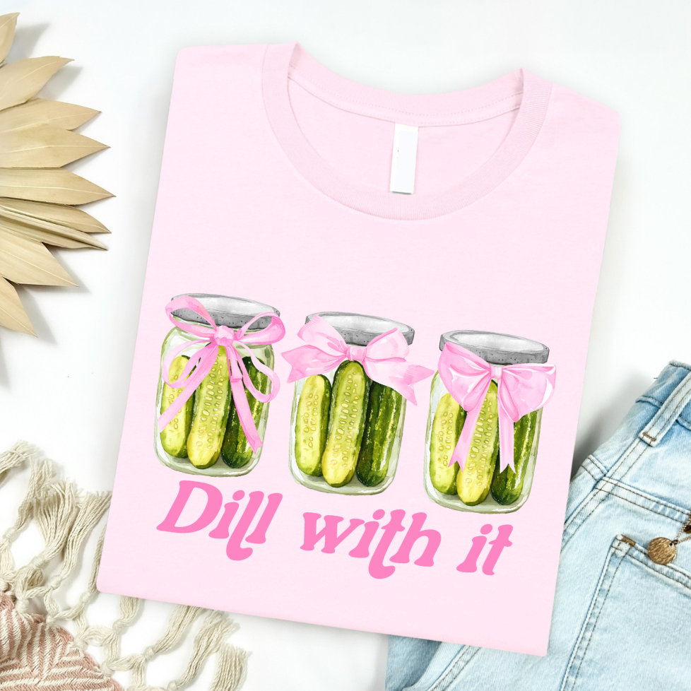 Light pink women's graphic t-shirt featuring a pickle jar design from FestiviTees, casual apparel for women.