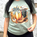 Sage green women's T-shirt featuring a pumpkin with cowboy boot graphic, casual apparel by FestiviTees.