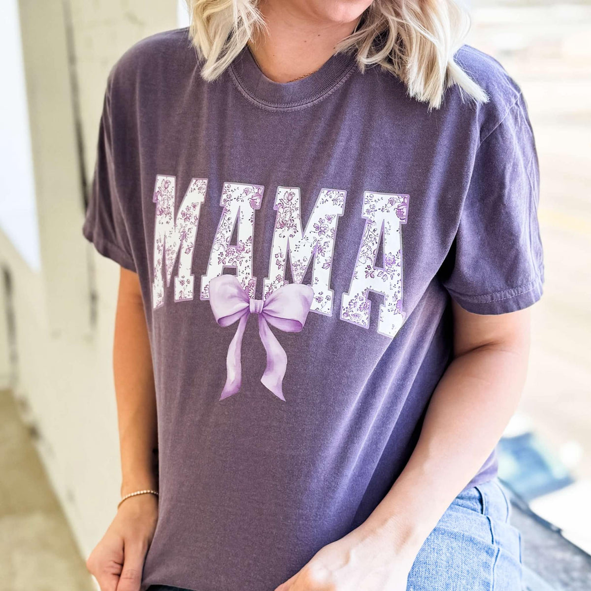 Purple Mama Bow graphic T-shirt for women by FestiviTees, featuring a colorful bow design on a comfortable purple tee.