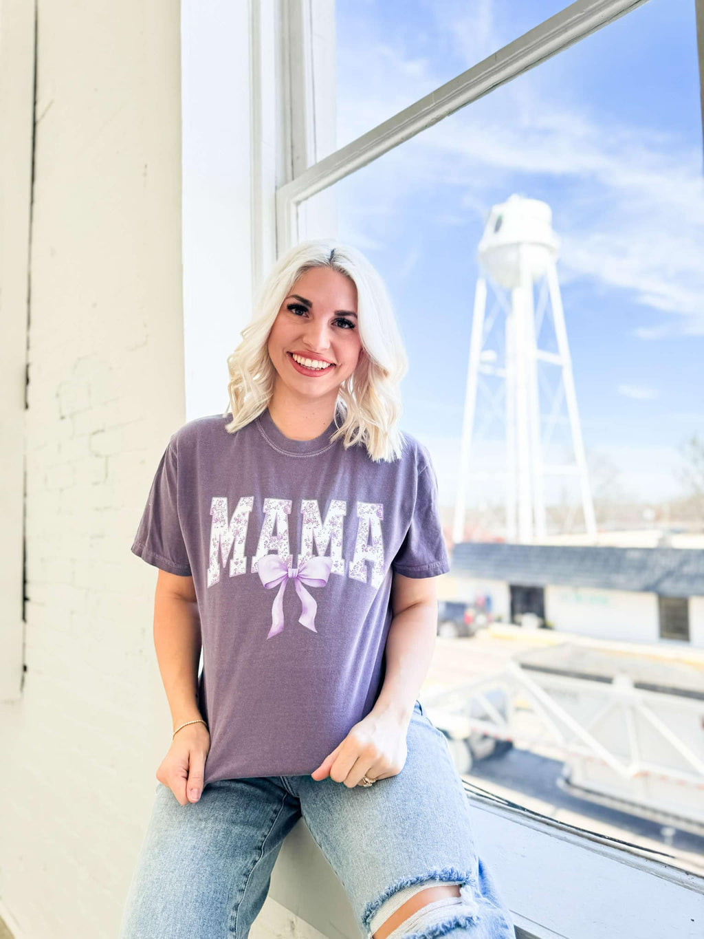 Purple Mama Bow graphic T-shirt for women by FestiviTees, featuring a colorful bow design on a comfortable purple shirt.