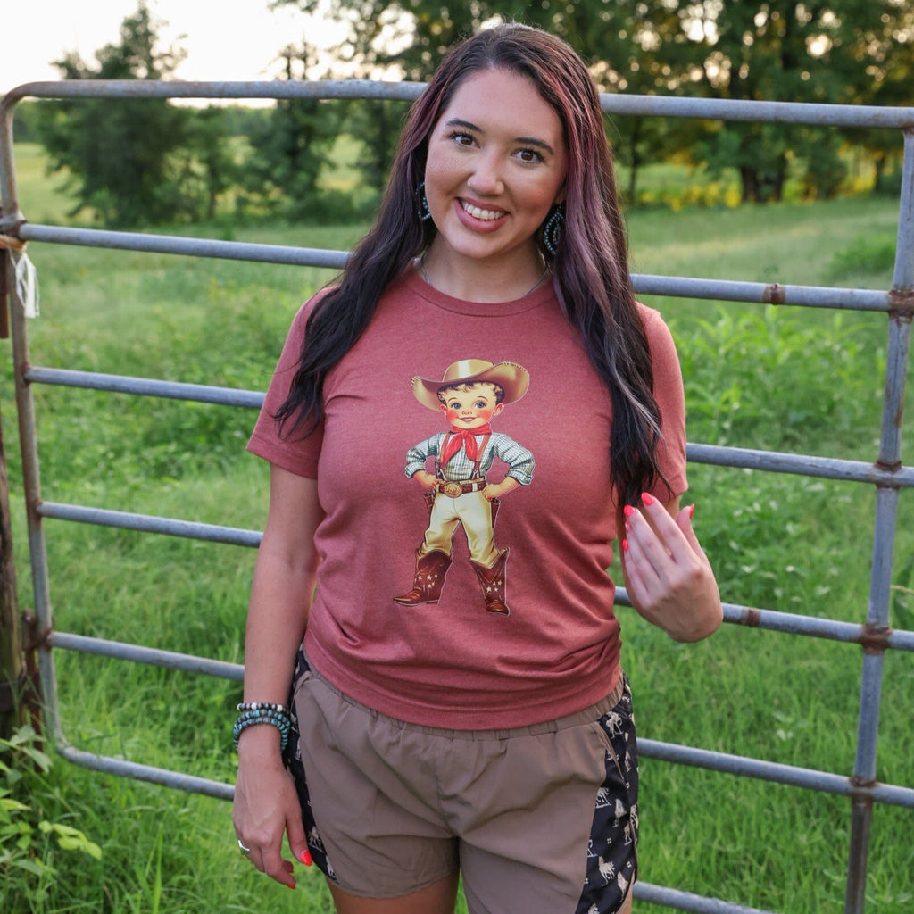 Women’s Retro Cowboy Kid soft graphic T-shirt by FestiviTees, featuring a vintage cowboy kid design on a casual tee.