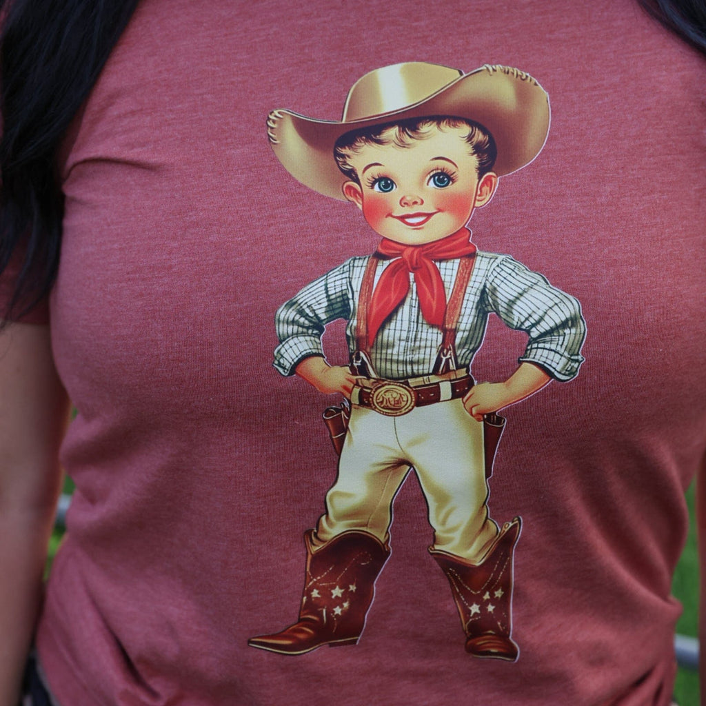 Women’s Retro Cowboy Kid Soft Graphic T-Shirt by FestiviTees featuring a vintage cowboy kid print on a casual tee.