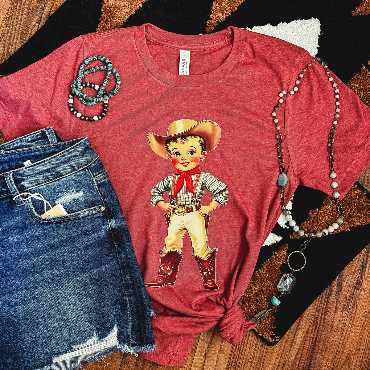 Unisex retro cowboy kid graphic T-shirt for women by FestiviTees, featuring a soft, vintage-style cowboy print on a casual tee.