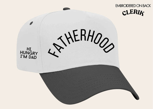 White cap featuring "Fatherhood" text on front, black bill, by GRACE+EMMA from Southern Grace, displayed on a flat surface.
