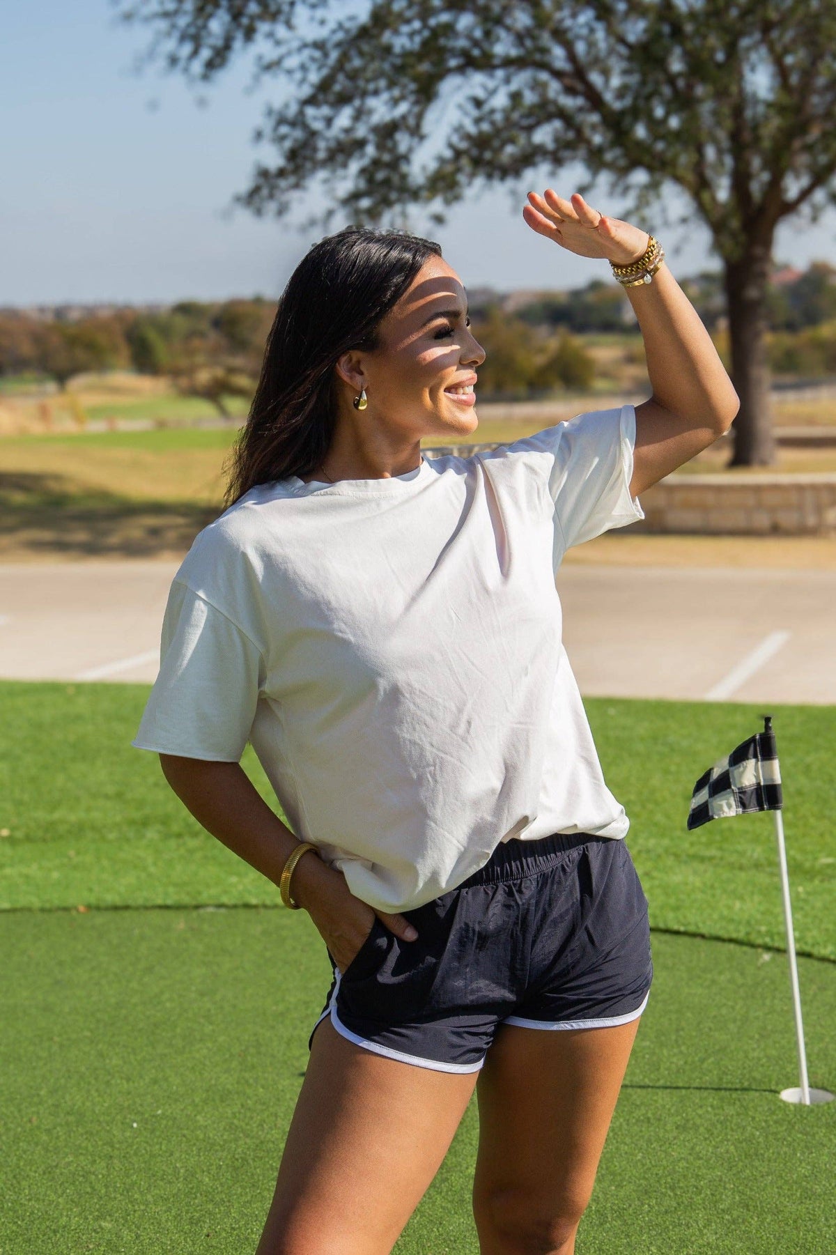 Black Go-Getter Shorts by GRACE+EMMA with a relaxed fit and belt loops, styled on a model for casual summer wear.