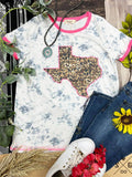 White Ringer Tee by GRACE+EMMA with leopard Texas design on marble pink background, casual and trendy women's t-shirt.