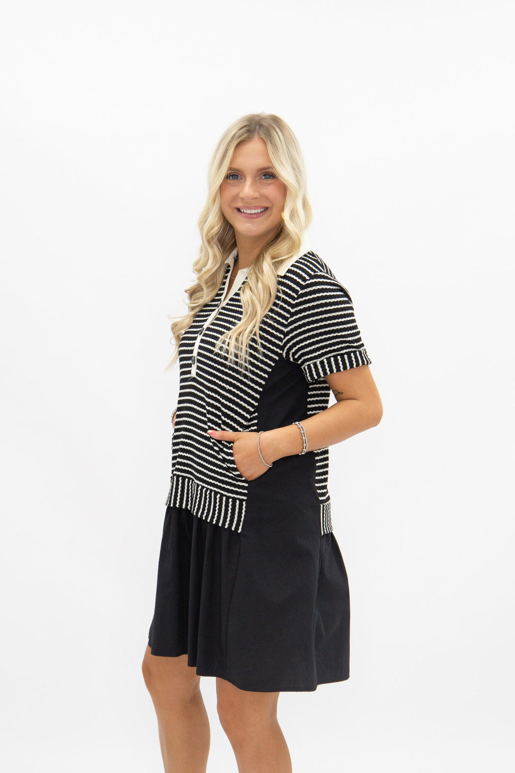 Black striped knit top with attached skirt, ladies dress by Grace+Emma, showcasing a stylish and coordinated casual outfit.