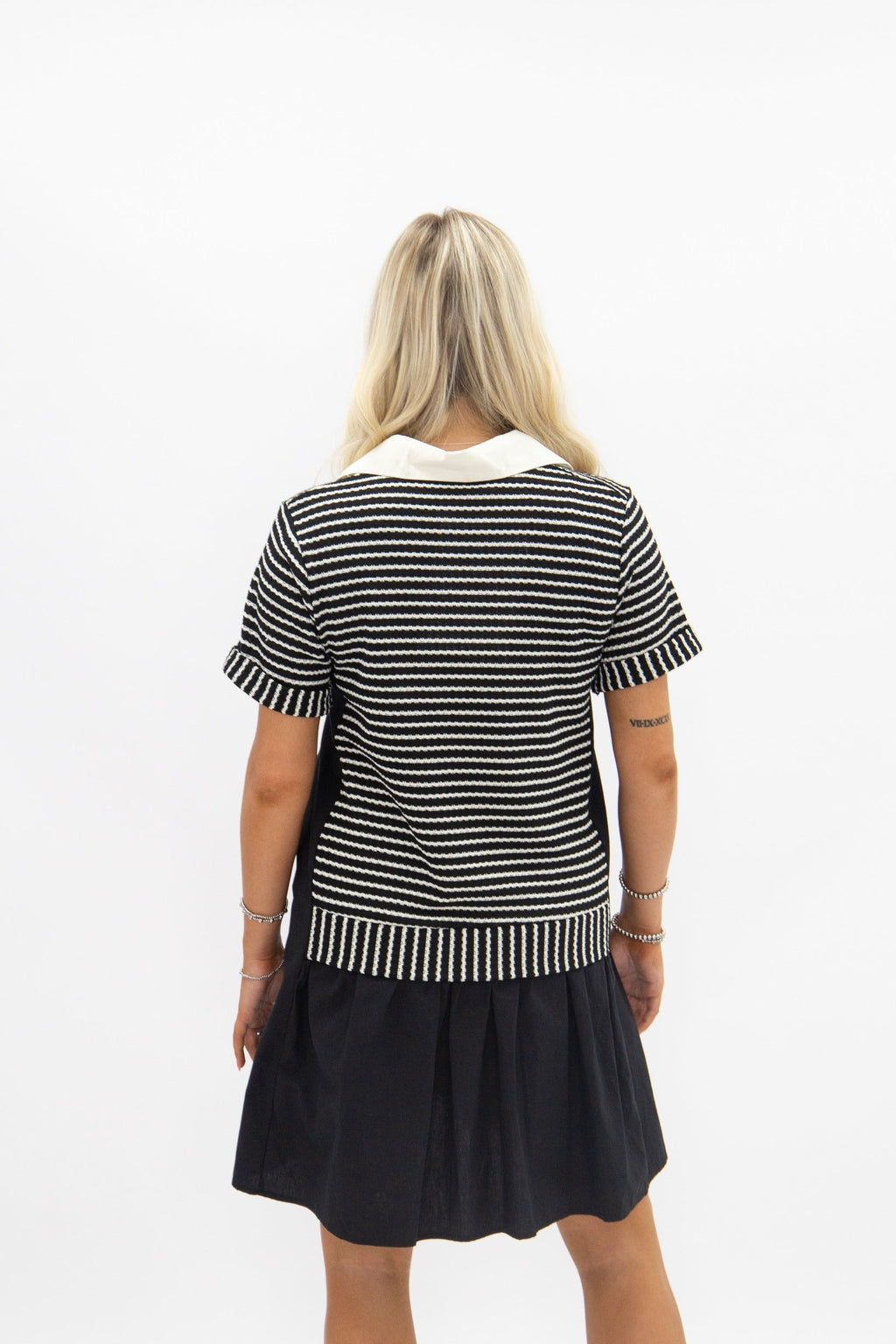 Black striped knit top with attached skirt, women's dress by Grace+Emma, stylish and comfortable fashion ensemble.