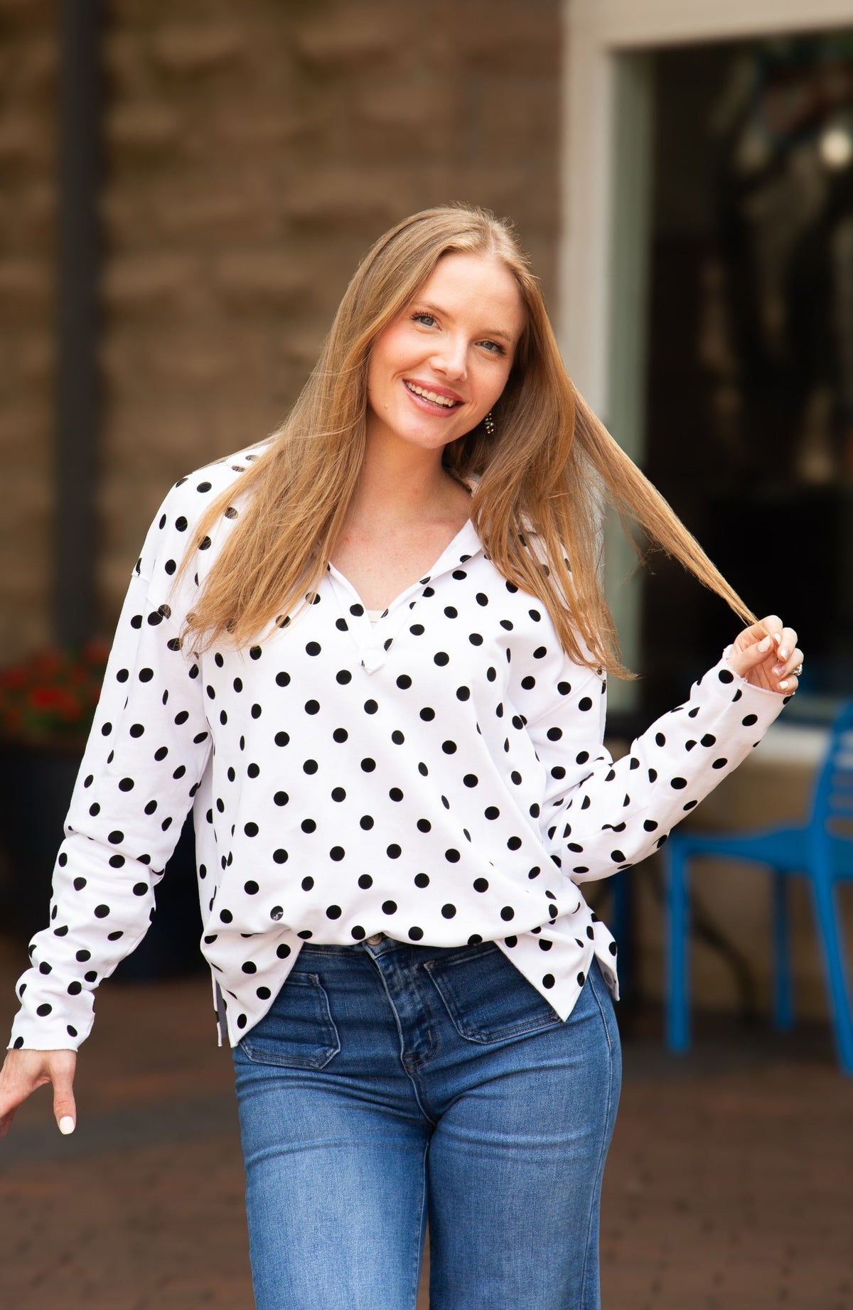 Black polka dot V-neck collared pullover for women by Grace+Emma, featuring long sleeves and a relaxed fit.