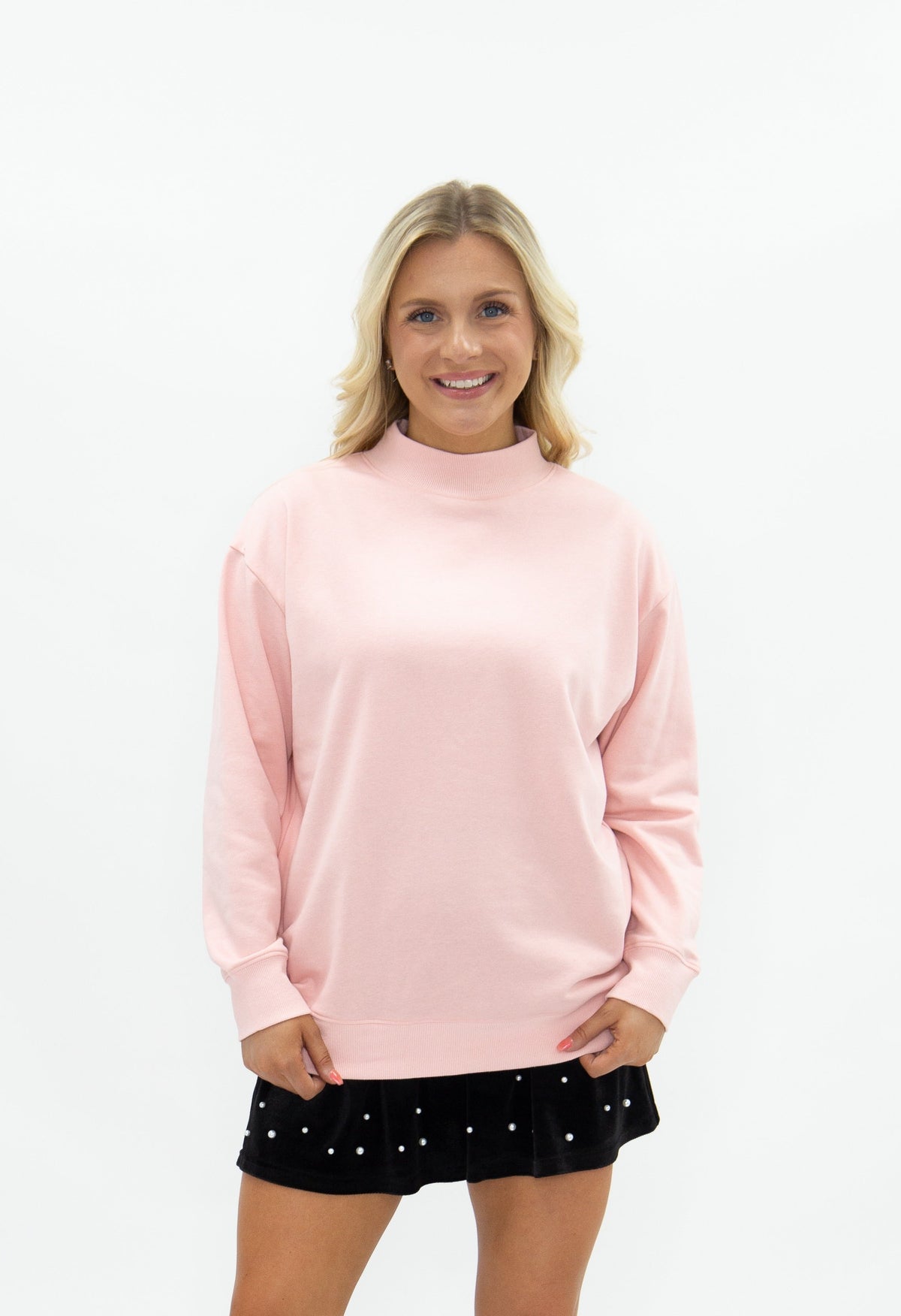 Light pink Grace+Emma ladies' mock neck sweatshirt, casual top with long sleeves and a cozy fit, shown on a model.