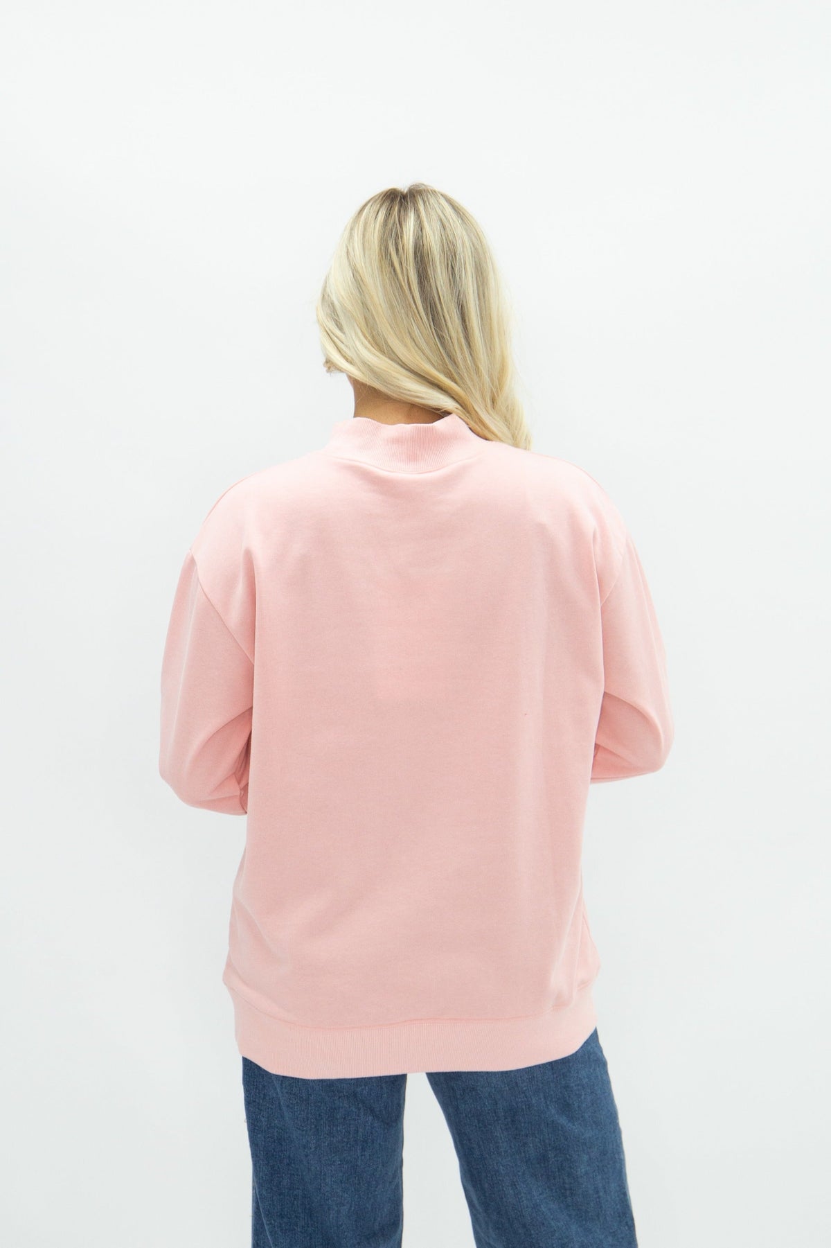 Light pink Grace+Emma ladies' mock neck sweatshirt, casual top with long sleeves and soft fabric, close-up front view.