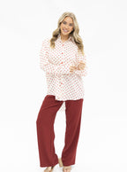 Grace+Emma Kathryn Classic Button-Up Ladies Top in red polka-dot fabric, featuring a stylish collar and button details.