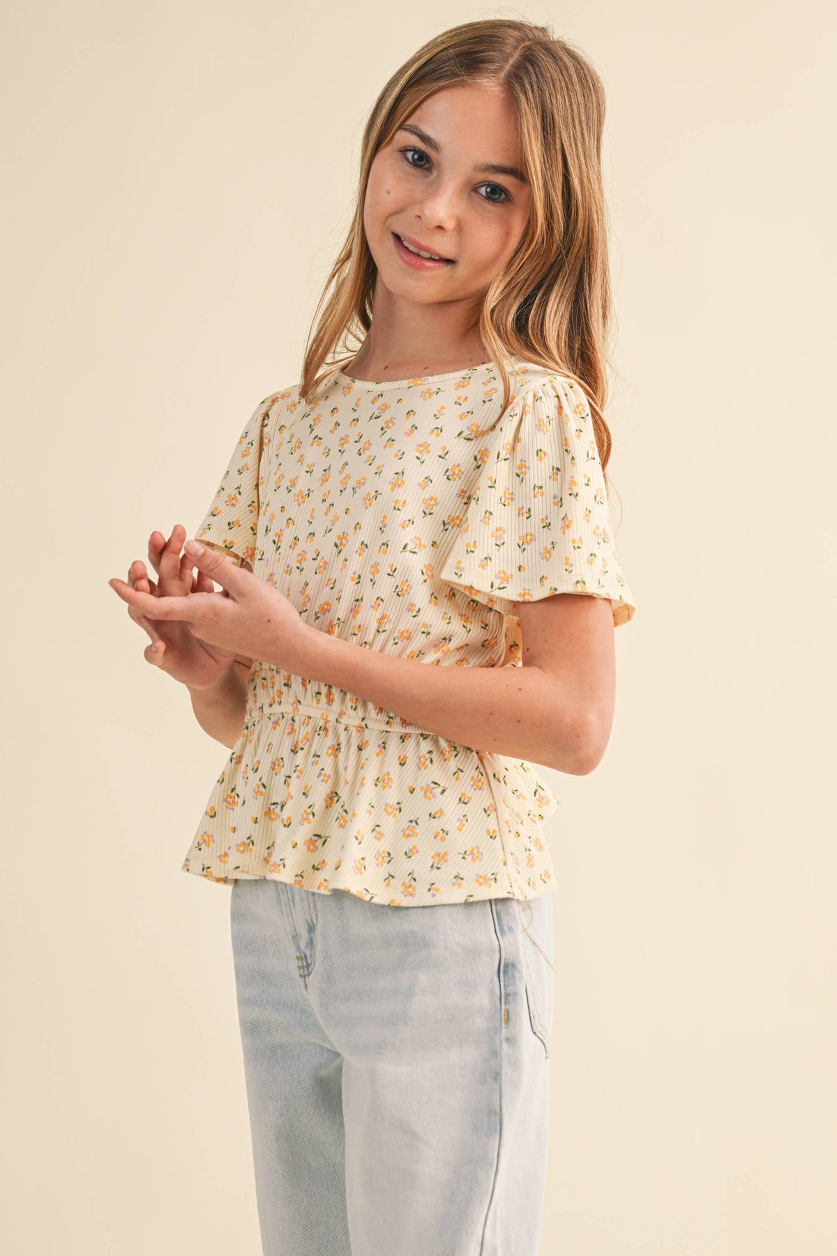 Heart and Arrow girls' peplum top with round neck and flutter sleeves for tween kids, stylish and comfortable for everyday wear.