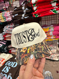 Black Trust God hat by JANES BLESSINGS featuring embroidered text, casual style, and adjustable strap.