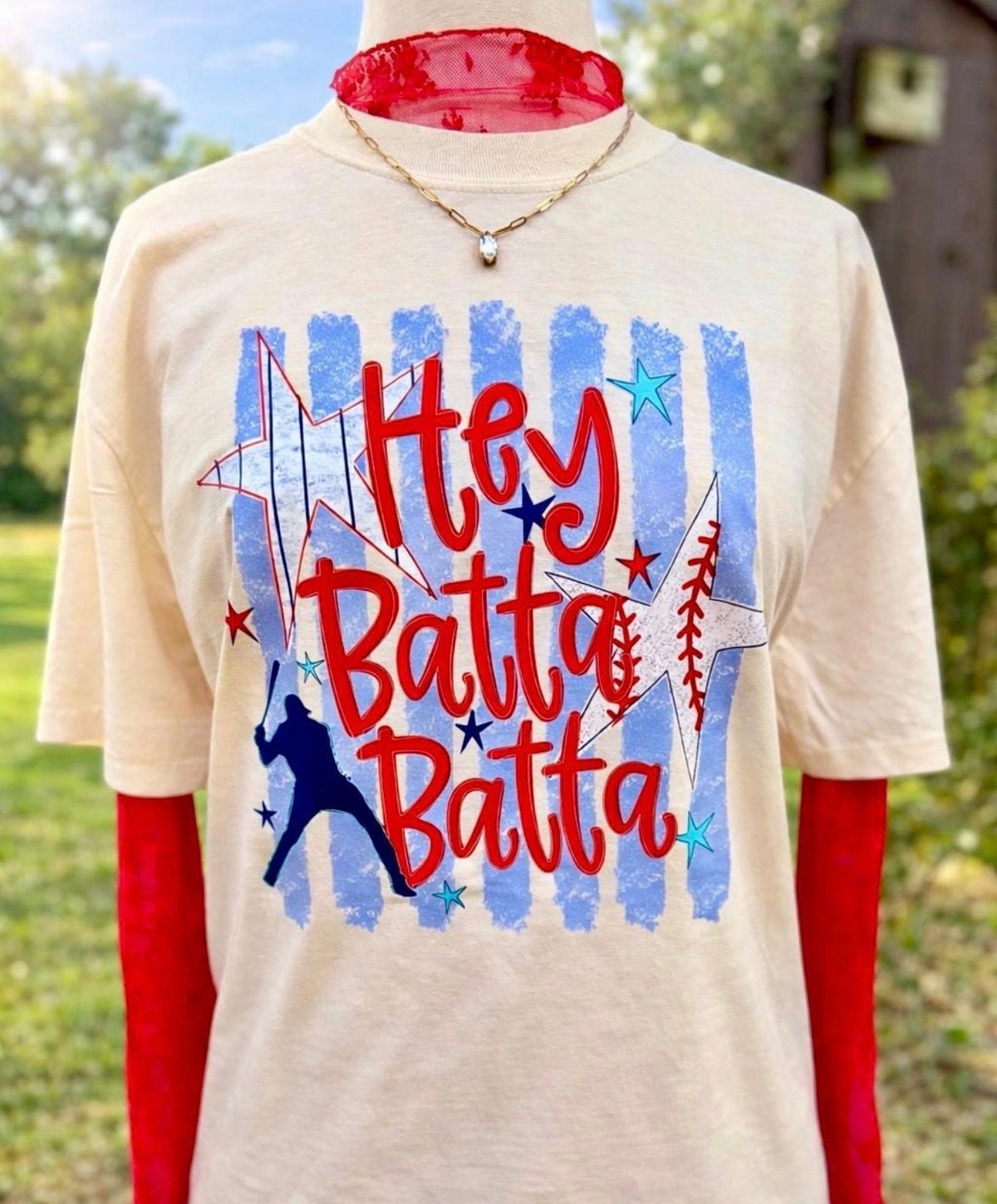 Janes Blessings Hey Batter Batter sweatshirt featuring bold text design and casual fit, displayed on a hanger.