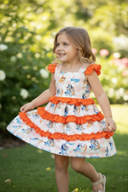 Kids Charm Online girl's dog-printed character dress with ruffle trim, featuring colorful dog illustrations and playful design.