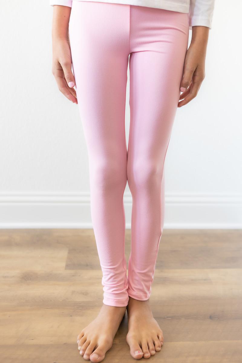 Bubblegum pink Mila & Rose® leggings for toddlers, soft stretchy fabric, close-up of the pink waistband and textured fabric.