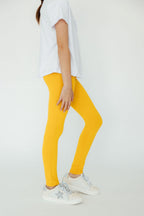 Mustard Mila & Rose® leggings for babies, featuring soft fabric and elastic waistband, suitable for infants aged 6-12 months.