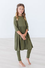 Olive Mila & Rose® leggings for babies, soft stretchy fabric, close-up of the green leggings with elastic waistband.