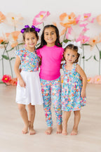 Baby girl wearing Mila & Rose preppy floral leggings in pastel colors, featuring a colorful flower pattern for ages 6-12 months.