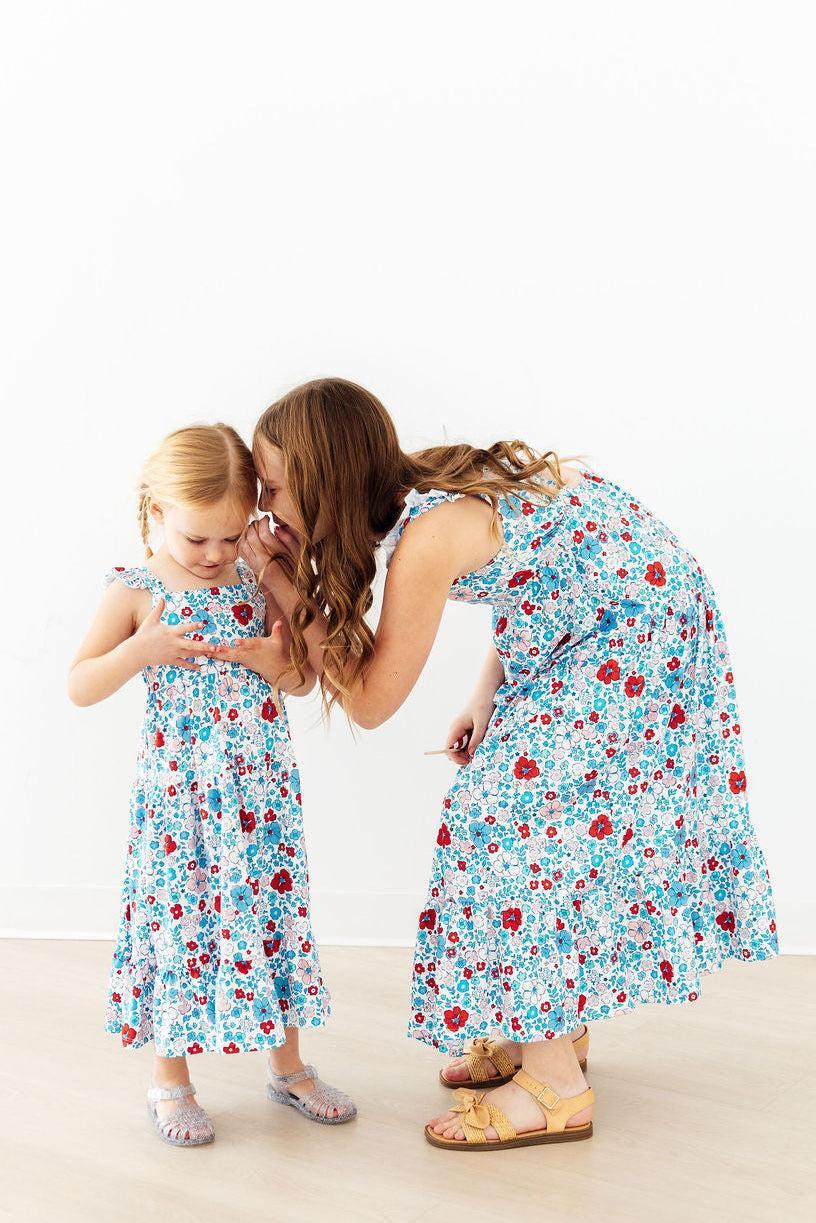 Mila & Rose patriotic petals ruffle maxi dress for toddlers with red, white, and blue floral design and ruffled details.