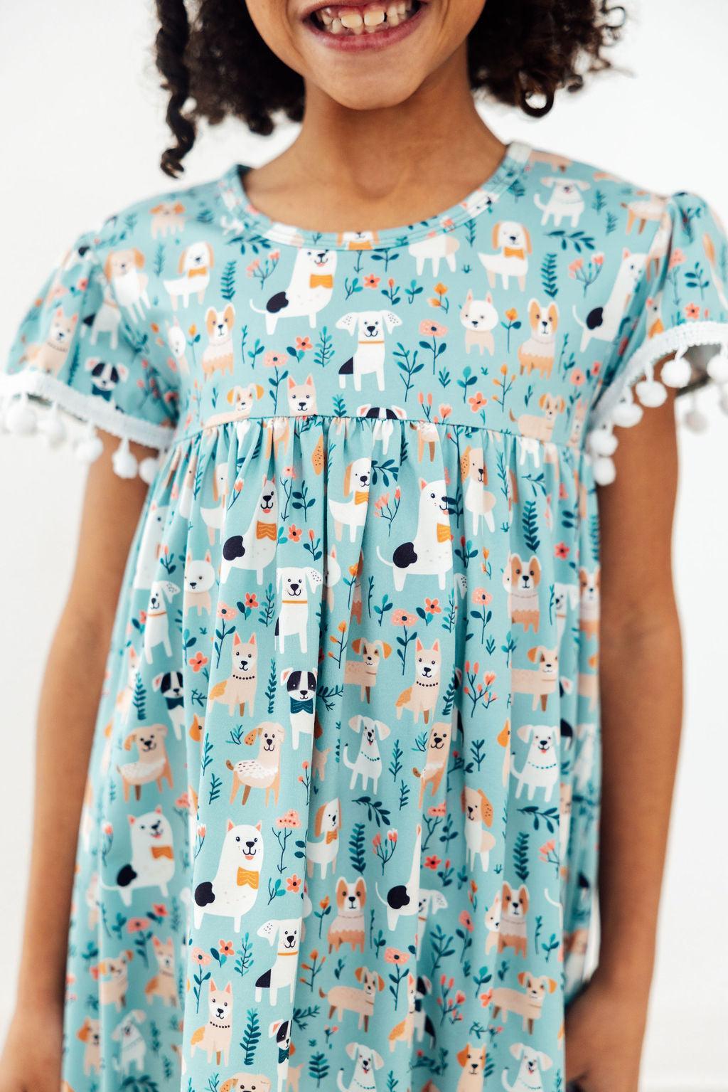 Cute Mila & Rose furry friends pom pom dress for 12-24 months, featuring soft fabric and adorable pom pom details.
