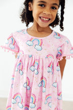 Mila & Rose® Sparkling Rainbows Pom Pom Dress for toddlers with colorful pom poms and a playful rainbow design.