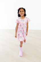 Mila & Rose sparkling rainbows pom pom dress for toddlers, featuring colorful pom poms and a cheerful, festive design.