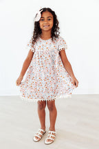 Mila & Rose® Unicorn Soiree Pom Pom Dress for toddlers, pink and white dress with colorful pom poms and festive design.