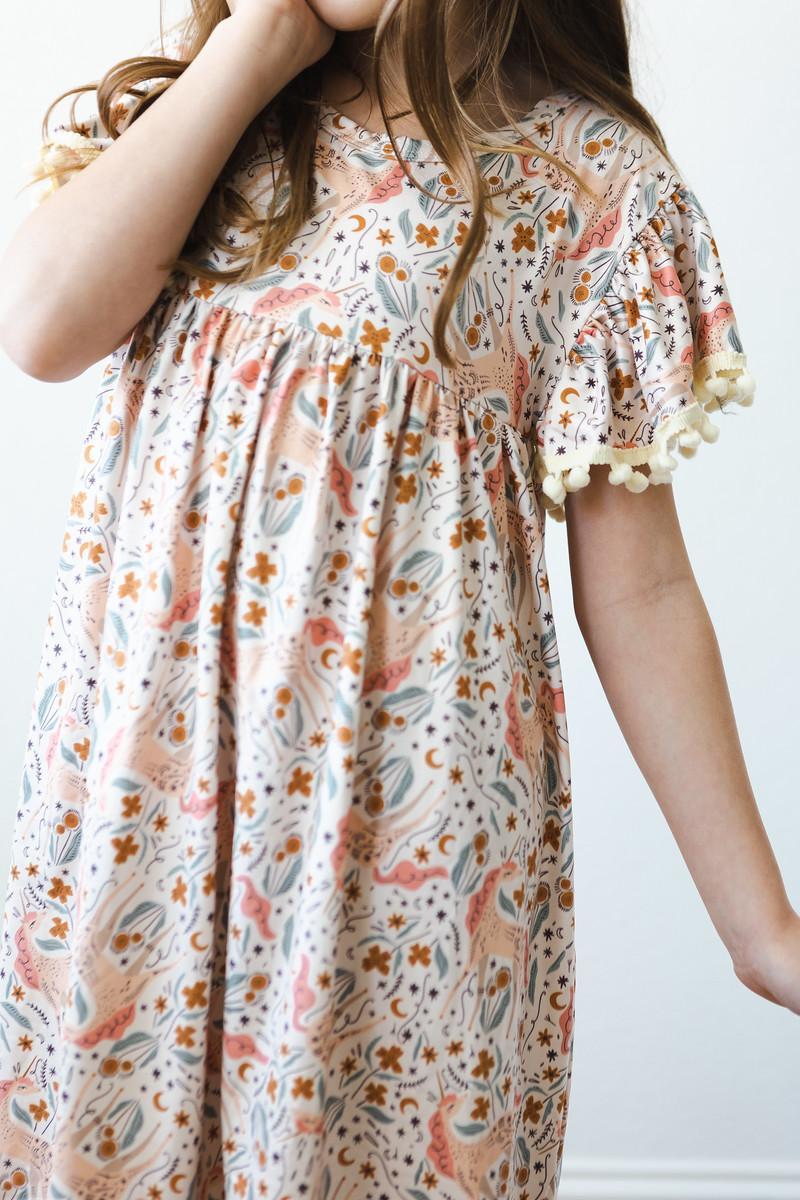 Mila & Rose unicorn-themed Pom Pom Dress for toddlers, featuring colorful pom poms and playful details for special occasions.