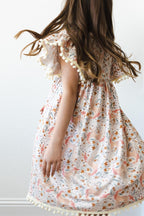Mila & Rose unicorn-themed pom pom dress for girls, featuring colorful pom poms and a playful design for ages 12-24 months.