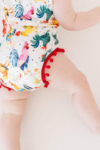 Mila & Rose® Rooster Pom Pom Romper for babies, featuring soft fabric with colorful pom pom accents, suitable for 0-6 months.