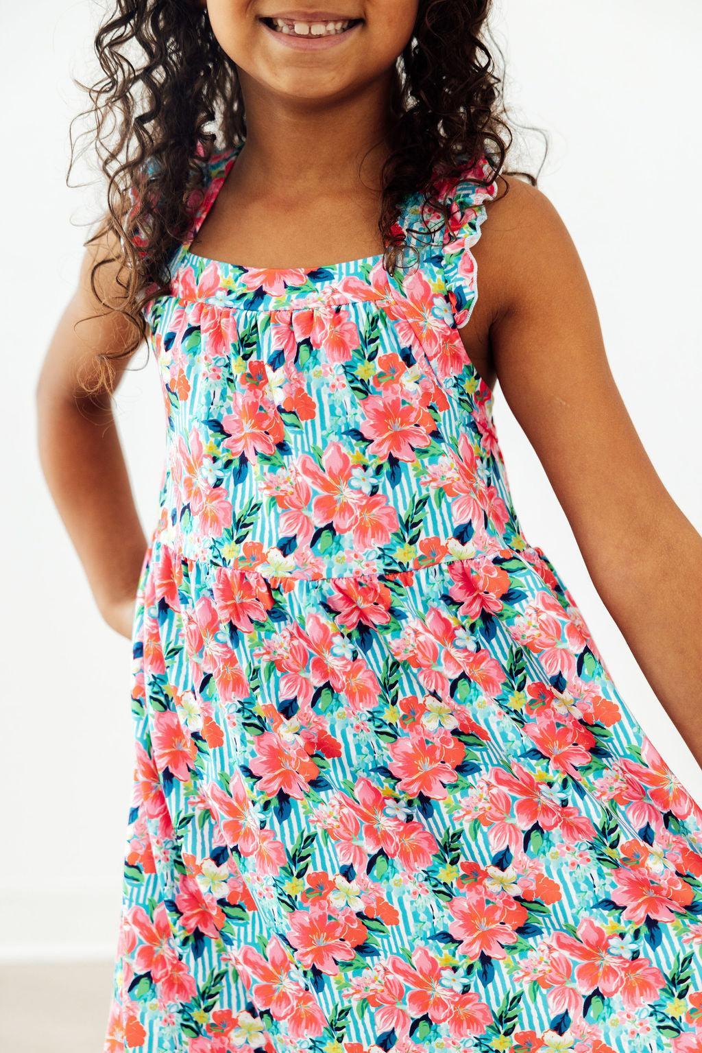 Mila & Rose Petals in Paradise Ruffle Cross Back Dress for toddlers, pink floral pattern with ruffle details and cross-back design.