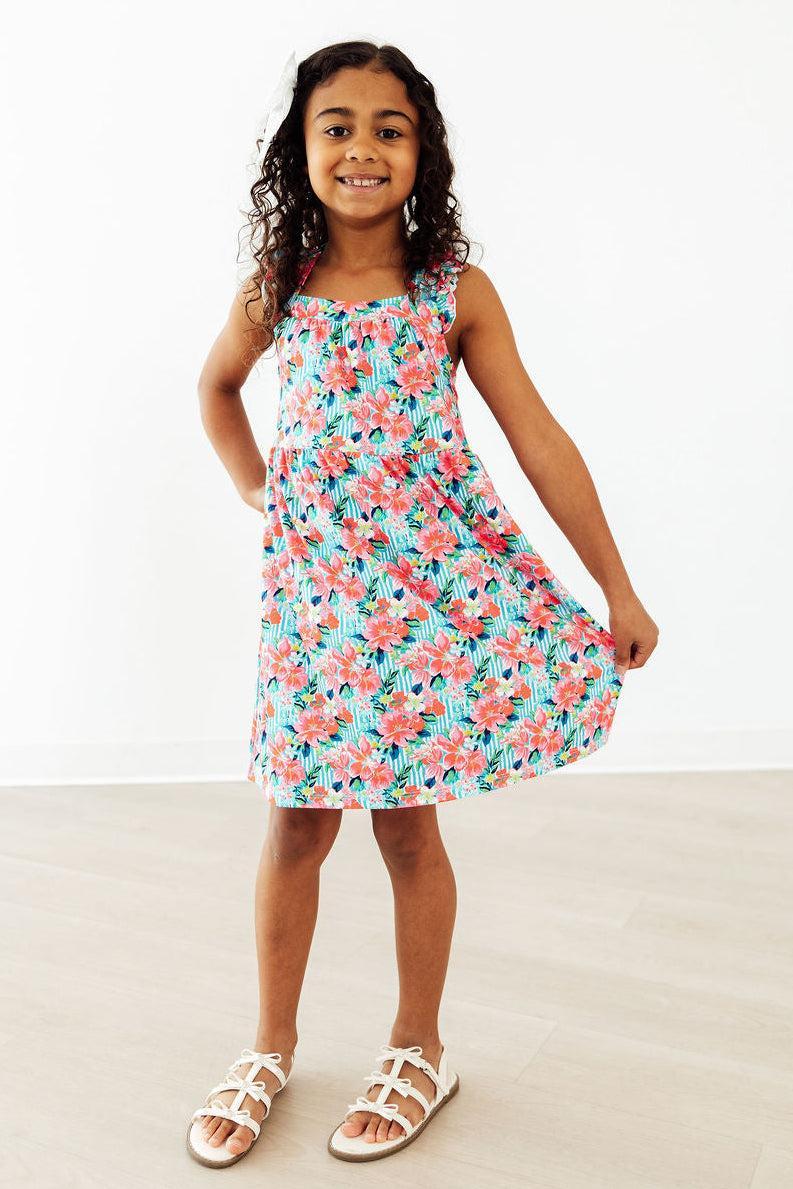 Mila & Rose Petals in Paradise Ruffle Cross Back Dress for toddlers, white dress with ruffle details and cross-back design.