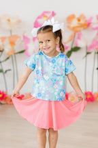 Pink ruffle pocket tee for toddlers by Mila & Rose, featuring a springtime splendor design in size 12-24 months.