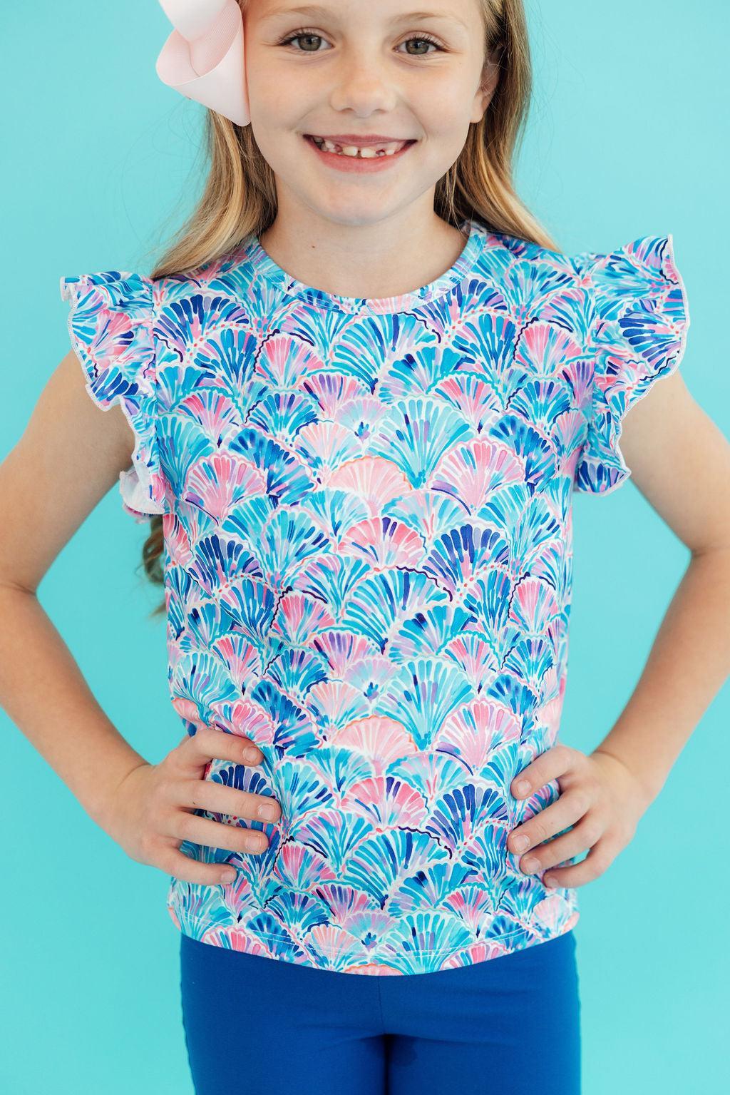 Mila & Rose seaside shells ruffle tee for toddlers, short-sleeve design with playful shell pattern and ruffled neckline.